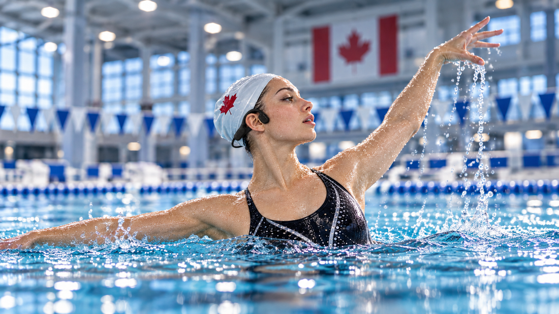 Artistic swimmer wearing OPN Sound Swym+ bone conduction headphones during indoor pool training with Canadian flag in the background.