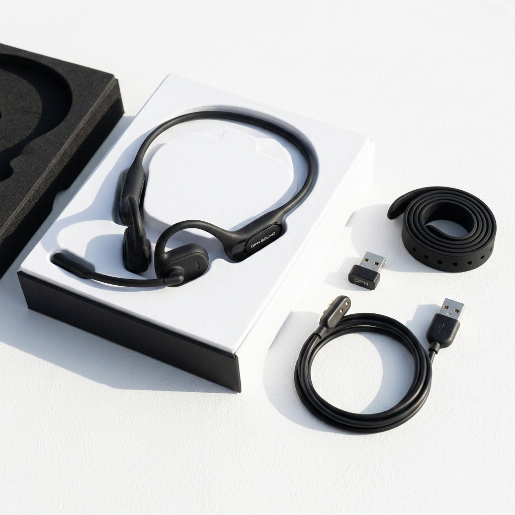 Box contents of the OPN Sound Chat Pro: black open-ear headset, charging cable, USB dongle, and strap.