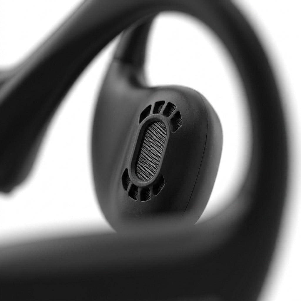 Macro detail of OPN Sound Aperto headphones showing the matte black directional audio speaker port.